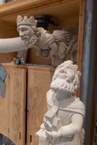 A stone grotesque carving of king Athelstan, in the background a clay sculpture can also be seen. 